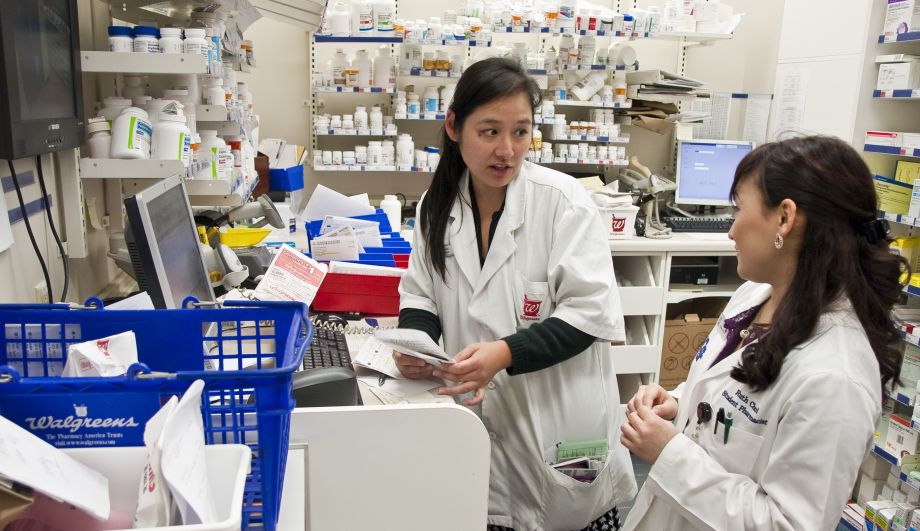 UCSF student in PharmD program practice experience in Wallgreens with pharmacy preceptor surrounded by medications