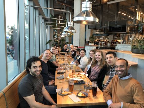 large group eating a meal, view from one end.