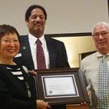 Koda-Kimble holds award with Schell and Weisser.
