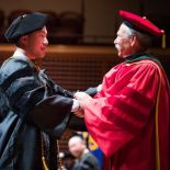 graduate and Guglielmo dressed in regalia