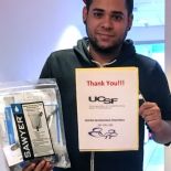 staff member holds one water filter and a thank you note.