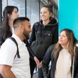 Students in front of a pillar with a &quot;UCSF&quot; banner