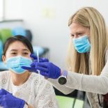 Clinard shows a student how to administer a vaccine.