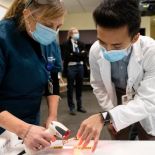 Aludino and employee record dose of vaccine