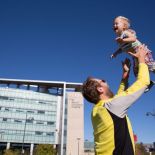 Man throwing child into the air