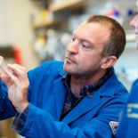 Gartner holding a petri dish