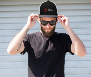 Man wearing a hat with The Kidney Project logo