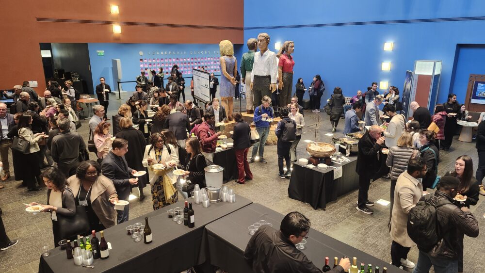 people networking in the lobby of a building at a summit