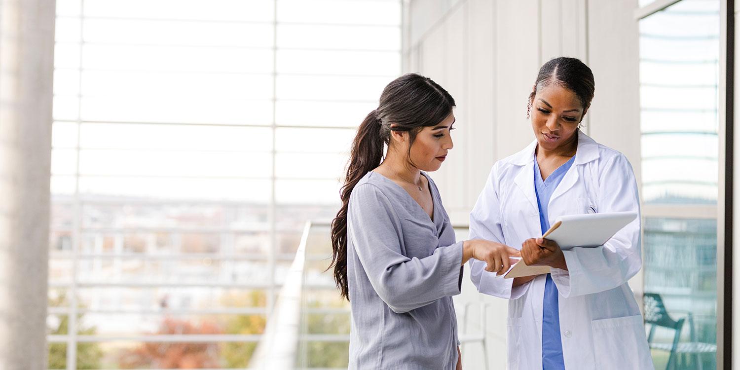 health care worker talking to a student