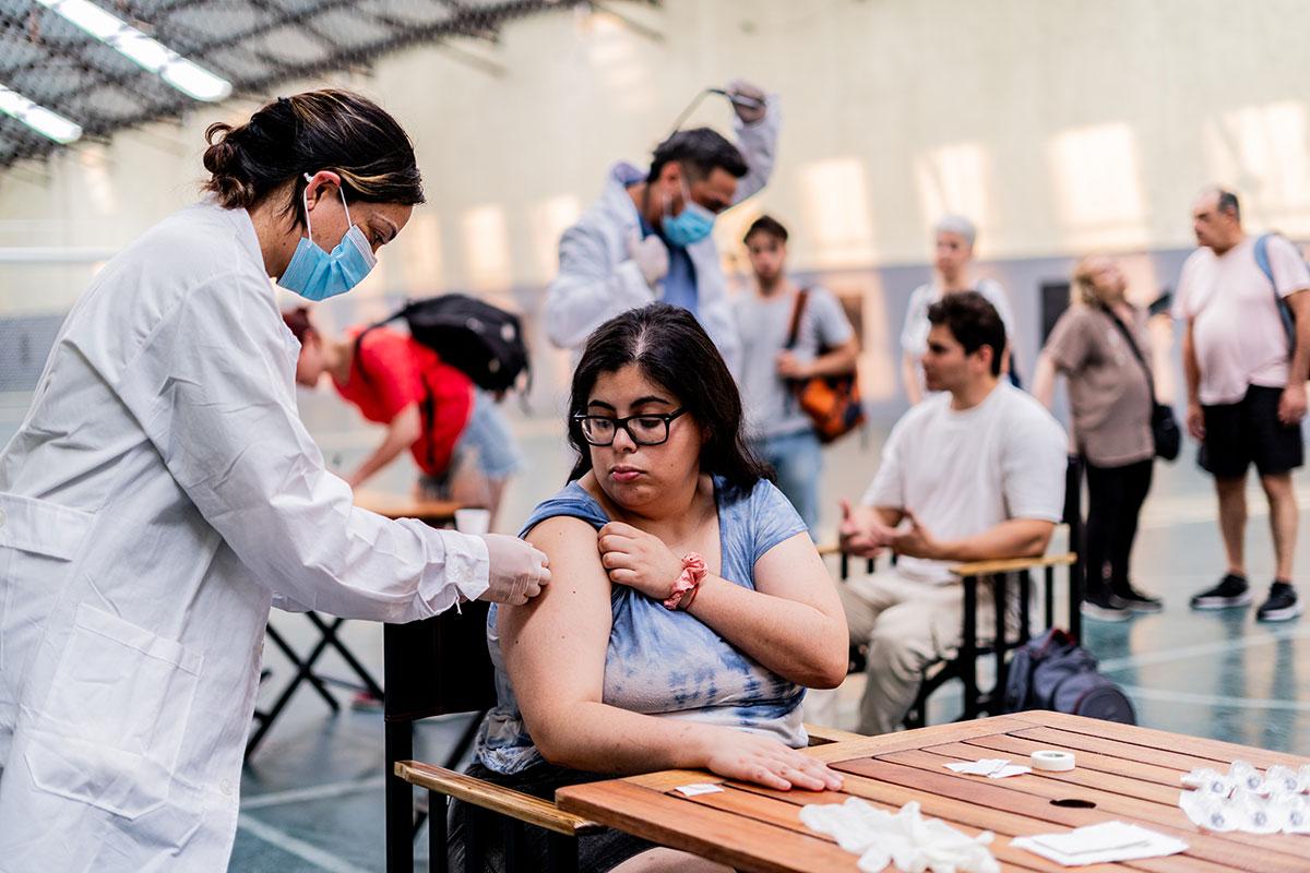 health care professional vaccinates woman in a community setting