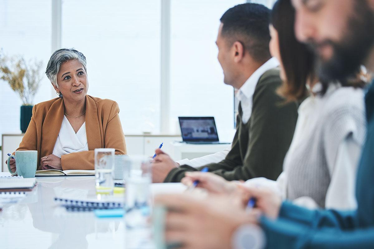 mature woman leading meeting
