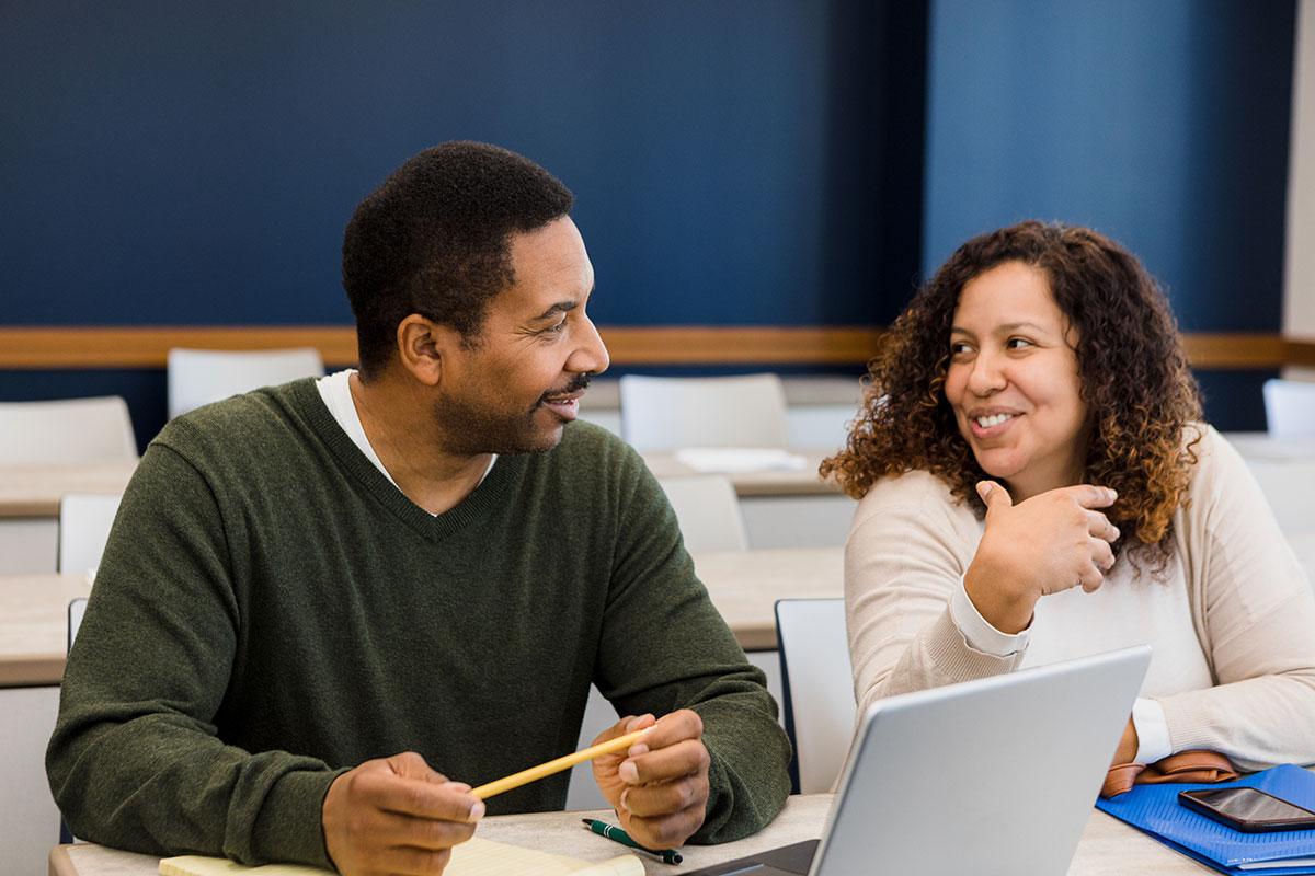 two colleagues smiling and talking